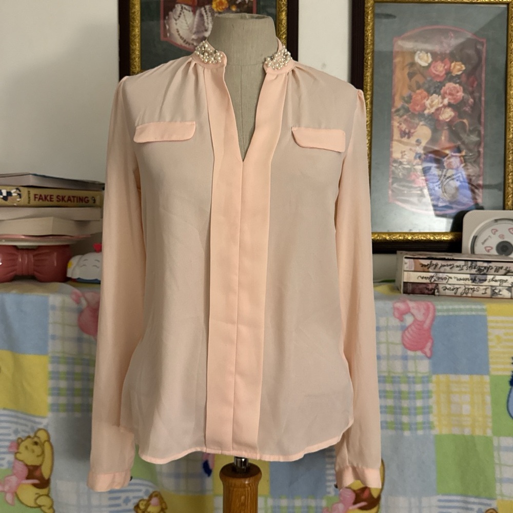 Candie’s pink blouse